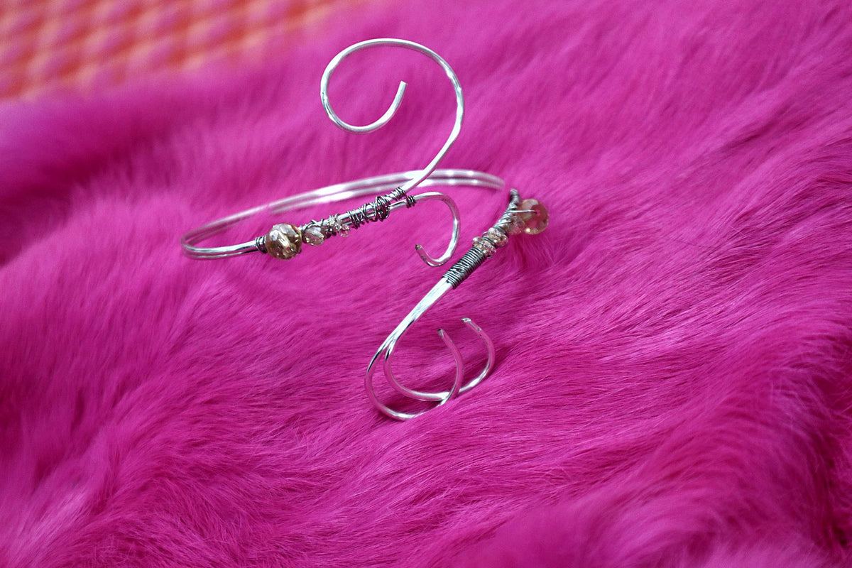 Silver-coloured swirl wire arm cuff with beads